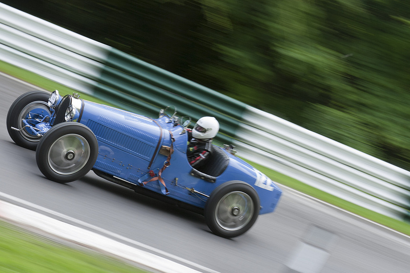 A blue Bugatti racing at Cadwell Park