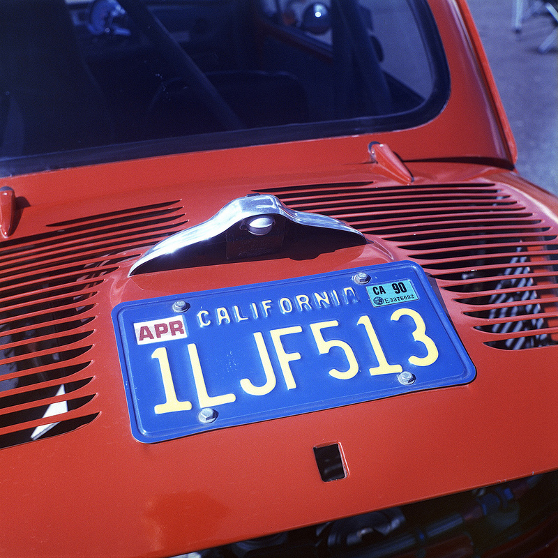 The bootlid of a Fiat Abarth, with a blue numberplate.