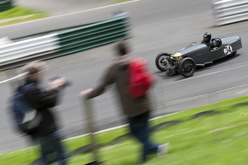 A morgan racing at Cadwell park, with spectators in the foreground