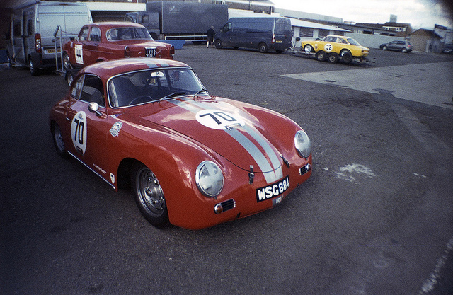 A red Porsche 356A in the paddock at Donington