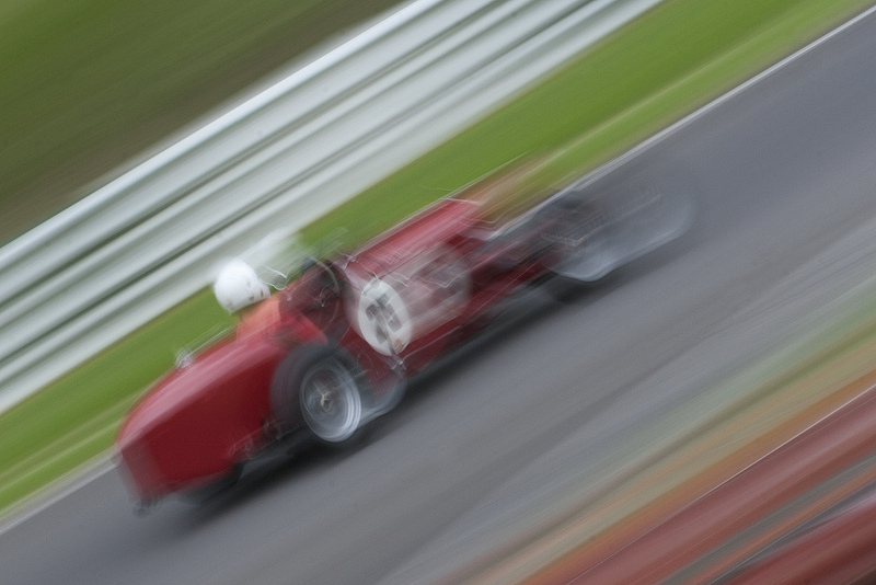 A very blurred photograph of a Riley racing car at Cadwell Park
