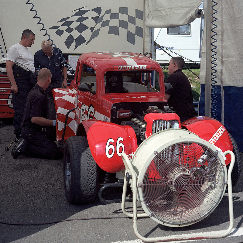 66_in_paddock A red Legends car sat in the paddock during the lunch break.