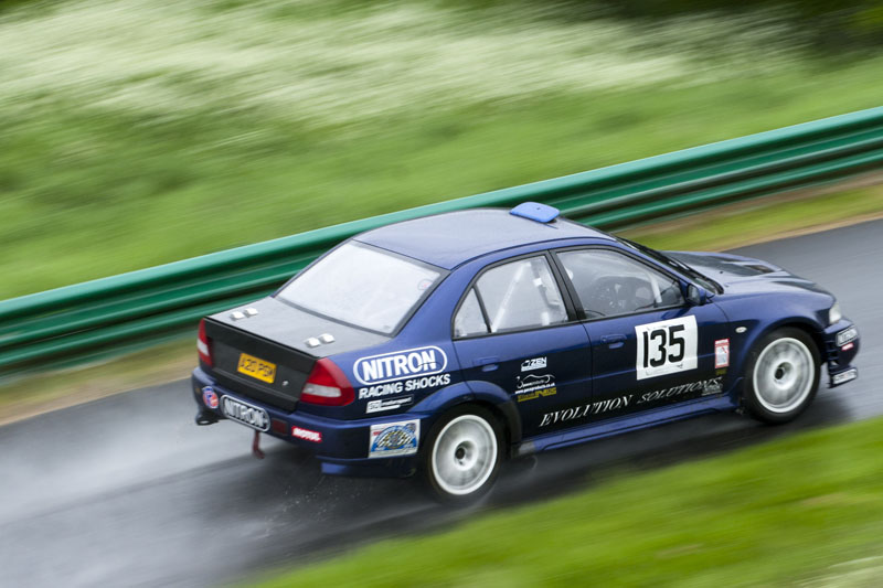 An Evo 7 racing through wet conditions at Harewood