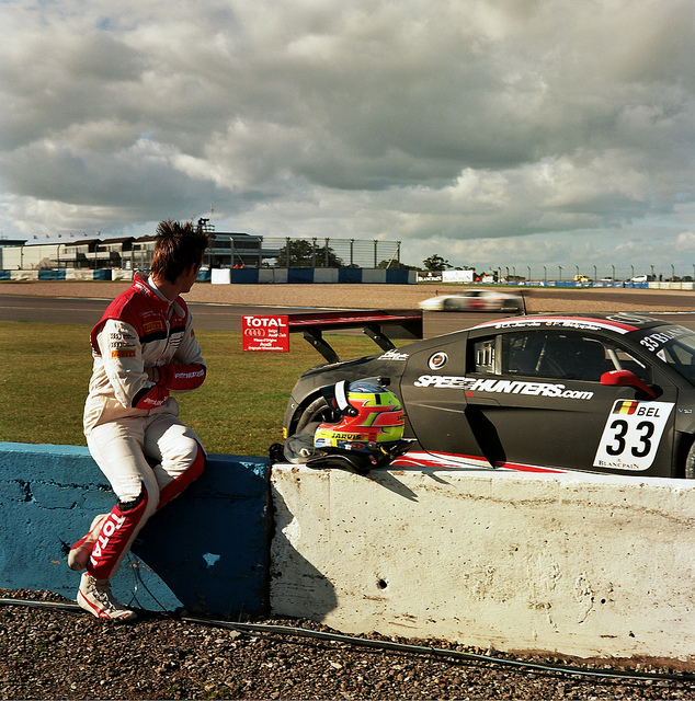 A driver sitting by a striken Audi at Donington Park