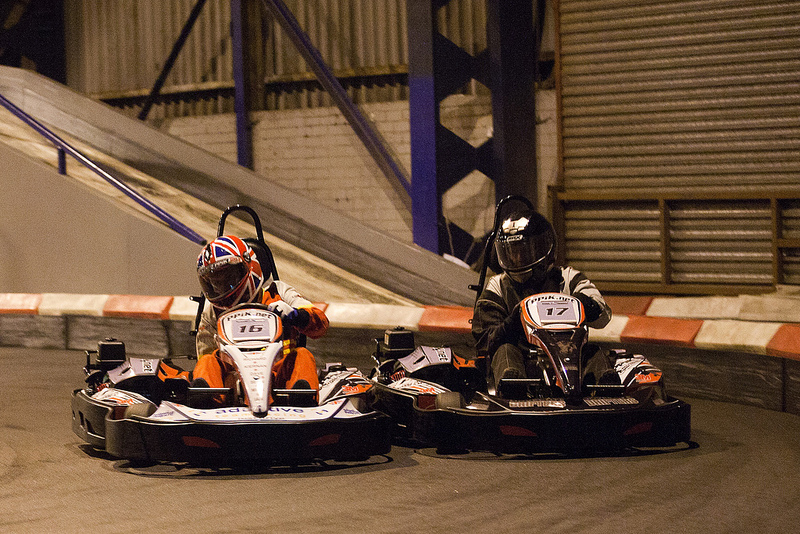Two karts side by side into turn 1