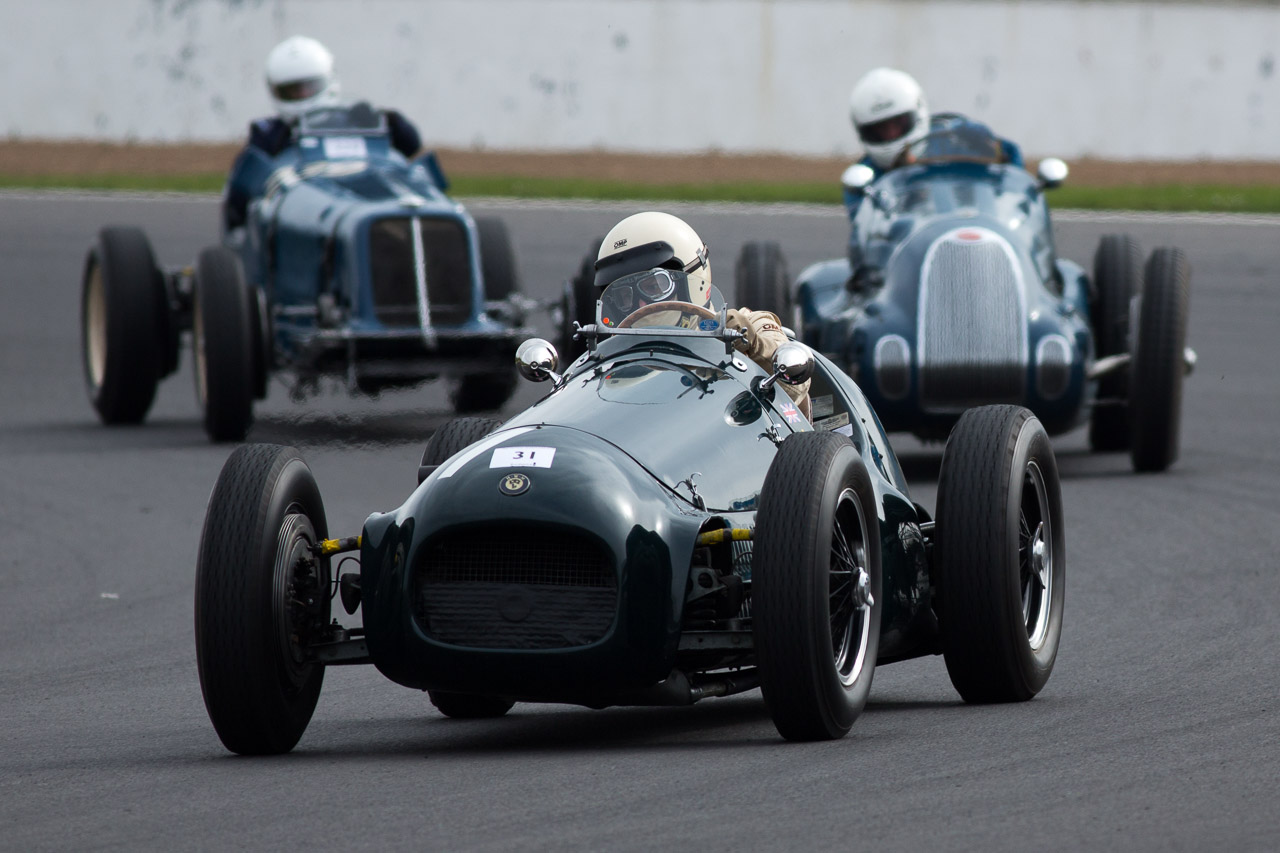 Three grand prix cars going around Luffield at Silverstone - vintage motorsport photography