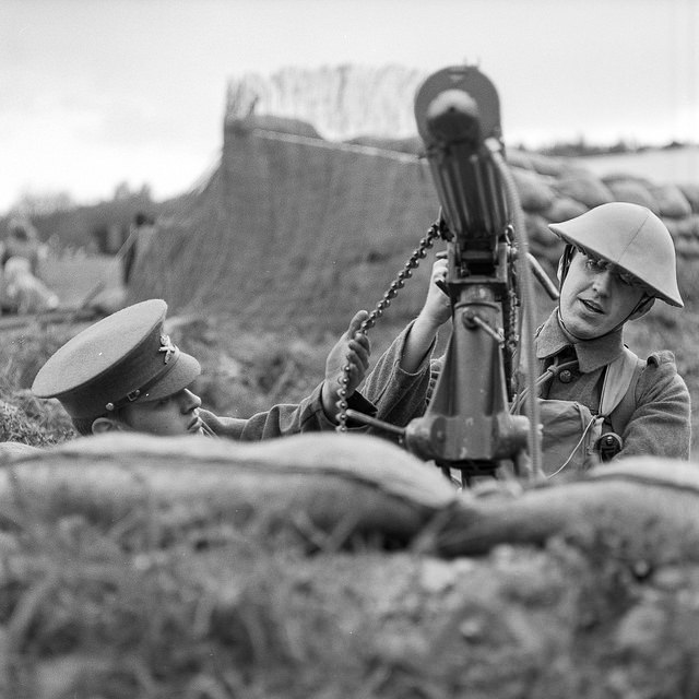 Two re-enactors prepare a machine gun at the Apedale Valley Railway Tracks to the Trenches event.